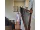 Spacious hallway featuring hardwood floors, decorative railings, and access to multiple rooms at 1755 Riverpark Dr, Dacula, GA 30019