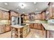 Modern kitchen with custom cabinets, stainless appliances, an island with cooktop, and granite countertops at 1755 Riverpark Dr, Dacula, GA 30019