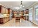 Gourmet kitchen with custom cabinets, stainless steel appliances, granite counters, and hardwood floors at 1755 Riverpark Dr, Dacula, GA 30019