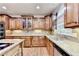 Spacious kitchen features granite countertops, custom wood cabinets, a tiled backsplash, and stainless steel appliances at 1755 Riverpark Dr, Dacula, GA 30019