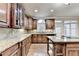 Kitchen with custom cabinets, granite counters, hardwood floors, recessed lights, and stainless steel appliances at 1755 Riverpark Dr, Dacula, GA 30019