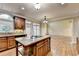 View of the kitchen with granite island cooktop and stainless steel appliances and open floorplan at 1755 Riverpark Dr, Dacula, GA 30019