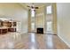 Open living room boasts hardwood floors, fireplace, and vaulted ceilings with natural light from large windows at 1755 Riverpark Dr, Dacula, GA 30019