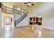 Grand living room with hardwood floors, staircase and entry to the kitchen and entry at 1755 Riverpark Dr, Dacula, GA 30019