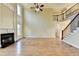 Inviting living room featuring a fireplace, hardwood floors, and an elegant staircase with iron railings at 1755 Riverpark Dr, Dacula, GA 30019