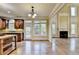 Open-concept floor plan with a kitchen and living room featuring a fireplace, large windows, and hardwood floors at 1755 Riverpark Dr, Dacula, GA 30019
