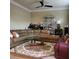 Spacious living room with a sectional sofa, ceiling fan, and glass display cabinet at 1755 Riverpark Dr, Dacula, GA 30019