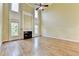 Large living room featuring hardwood floors, a fireplace, and a ceiling fan for added comfort at 1755 Riverpark Dr, Dacula, GA 30019