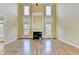 Spacious living room with fireplace, hardwood floors, and natural light from the many windows at 1755 Riverpark Dr, Dacula, GA 30019