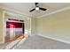 Spacious living room area with tan walls, tan carpet, and view into dining area at 1755 Riverpark Dr, Dacula, GA 30019