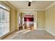 Light-filled living room connects to another area featuring tan walls and carpet at 1755 Riverpark Dr, Dacula, GA 30019