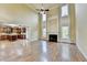 Open-concept living room with hardwood floors, fireplace, and view into the kitchen at 1755 Riverpark Dr, Dacula, GA 30019