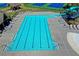 An aerial view showcasing a sparkling blue swimming pool with a water slide and plenty of lounge chairs for residents at 1755 Riverpark Dr, Dacula, GA 30019
