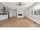 Inviting living room featuring a modern fireplace, gleaming hardwood floors, and abundant natural light from large windows at 1926 Camellia Dr, Decatur, GA 30032