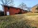 View of the brick exterior and large backyard on an overcast day at 2480 Sewell Mill Rd, Marietta, GA 30062