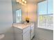 Bright bathroom with quartz countertop, single sink vanity, and a window providing natural light at 4320 Sims Park Overlook, Suwanee, GA 30024