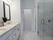 Modern bathroom featuring dual sinks, quartz countertops, marble tile flooring and shower at 4320 Sims Park Overlook, Suwanee, GA 30024
