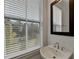 Bathroom featuring a modern sink, faucet, large window, and exterior nature views at 4320 Sims Park Overlook, Suwanee, GA 30024