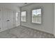 Bright bedroom features plush carpeting, natural light from the windows, and closet with double doors at 4320 Sims Park Overlook, Suwanee, GA 30024