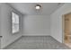 Carpeted bedroom with bright light and an ensuite bathroom with tile flooring at 4320 Sims Park Overlook, Suwanee, GA 30024