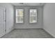 Bright bedroom features plush carpeting and two windows providing natural light at 4320 Sims Park Overlook, Suwanee, GA 30024