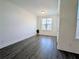 Minimalist bedroom with gray flooring, white walls, and a large window at 4320 Sims Park Overlook, Suwanee, GA 30024