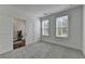 Cozy bedroom featuring plush gray carpeting, two bright windows and neutral wall paint at 4320 Sims Park Overlook, Suwanee, GA 30024