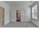 Clean bedroom featuring plush gray carpeting, bright window and slider door access at 4320 Sims Park Overlook, Suwanee, GA 30024