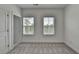 Bedroom with light-gray carpeting, white walls, and two windows for natural light at 4320 Sims Park Overlook, Suwanee, GA 30024