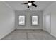 Bedroom with neutral walls, ceiling fan, two windows providing natural light, and plush carpeting at 4320 Sims Park Overlook, Suwanee, GA 30024