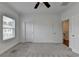 Spacious bedroom boasts neutral walls, ceiling fan, plush carpeting, and two doors at 4320 Sims Park Overlook, Suwanee, GA 30024