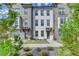 Charming brick townhome with a well-manicured lawn and lush landscaping, enhancing its curb appeal at 4320 Sims Park Overlook, Suwanee, GA 30024