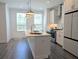 Modern kitchen with white cabinetry, stainless steel appliances, and a large island perfect for entertaining at 4320 Sims Park Overlook, Suwanee, GA 30024