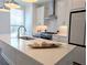 Bright, modern kitchen featuring white cabinets, stainless steel appliances, and a quartz countertop island at 4320 Sims Park Overlook, Suwanee, GA 30024