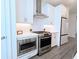 Modern kitchen with stainless steel appliances and white cabinets at 4320 Sims Park Overlook, Suwanee, GA 30024