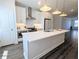 Contemporary kitchen features stainless steel appliances, a large island, and ample cabinet space at 4320 Sims Park Overlook, Suwanee, GA 30024