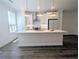 Bright kitchen with stainless appliances and a large island offering room for entertaining at 4320 Sims Park Overlook, Suwanee, GA 30024