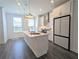 Modern, bright kitchen featuring stainless appliances, white cabinets, and an island with pendant lighting at 4320 Sims Park Overlook, Suwanee, GA 30024