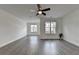 Spacious living room featuring hardwood floors, white walls, and a modern ceiling fan at 4320 Sims Park Overlook, Suwanee, GA 30024