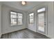 Bright living room with hardwood floors, large windows, and a patio door at 4320 Sims Park Overlook, Suwanee, GA 30024