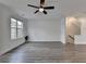 Spacious living room features wood-look flooring, a ceiling fan, and natural light at 4320 Sims Park Overlook, Suwanee, GA 30024