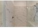Walk-in shower with marble-look tiling and bench seating at 4320 Sims Park Overlook, Suwanee, GA 30024