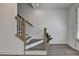 Inviting foyer with gray wood-look floors and staircase featuring wooden railings and black iron spindles at 4320 Sims Park Overlook, Suwanee, GA 30024