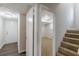 Staircase leading to finished basement with luxury vinyl plank flooring and access to front door at 3025 Creel Rd, Atlanta, GA 30349