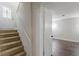 Staircase leading to finished basement with luxury vinyl plank flooring and access to front door at 3025 Creel Rd, Atlanta, GA 30349