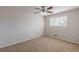 Bedroom with carpet flooring, ceiling fan, window with blinds, and neutral paint at 3025 Creel Rd, Atlanta, GA 30349