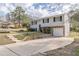 Split-level home featuring a stone facade, garage, and extended driveway at 3025 Creel Rd, Atlanta, GA 30349
