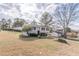 Split-level home featuring a well-maintained lawn and mature trees at 3025 Creel Rd, Atlanta, GA 30349