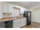 Updated kitchen featuring white cabinets, dark appliances, and laminate countertops at 3025 Creel Rd, Atlanta, GA 30349