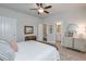 Comfortable bedroom features a wrought iron bed frame, soft bedding, and a view of an attached bathroom at 5315 Hidden Valley Ln, Cumming, GA 30028